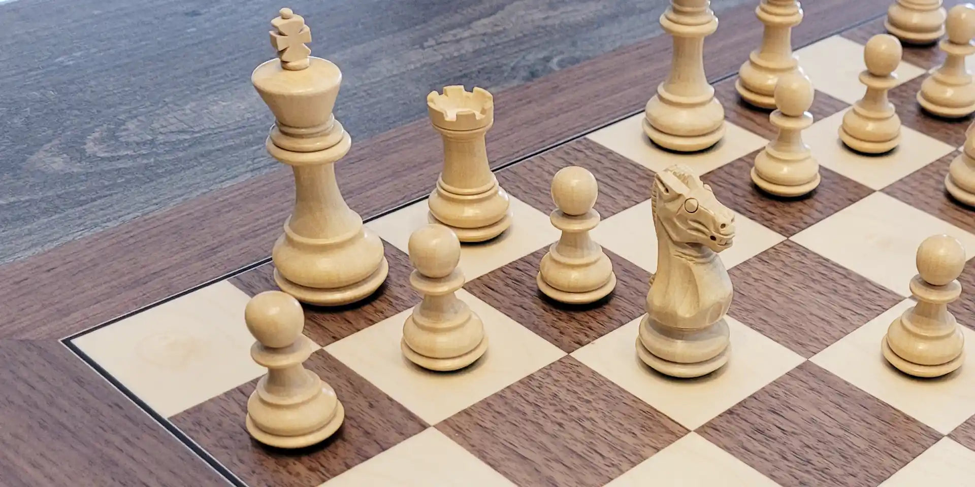 Grace chess pieces on walnut chess board
