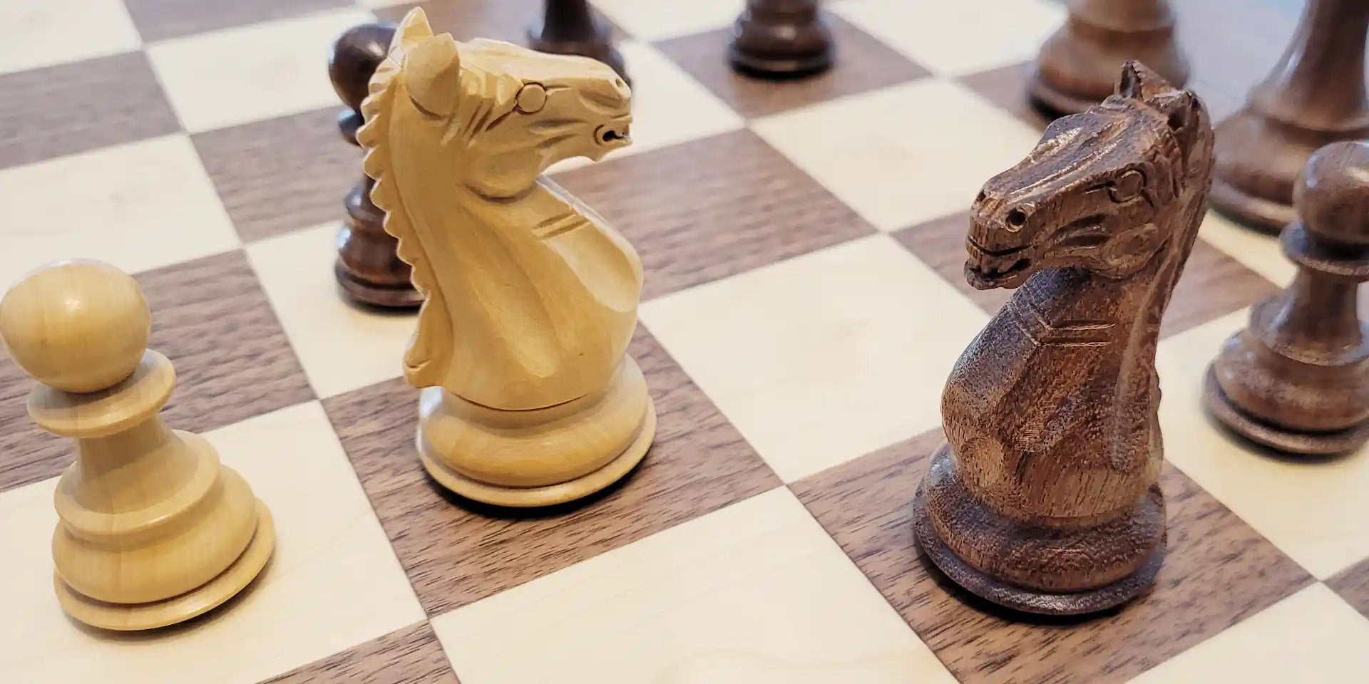 Supreme chess pieces on walnut chess board